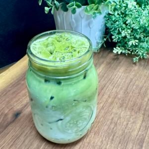 clear mug of iced greenish tea