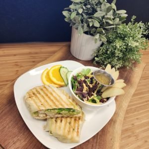 plate of grilled wrap, salad, fruit, veggies